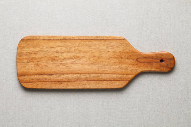 istock Handmade wood cutting board on the linen 898457780
