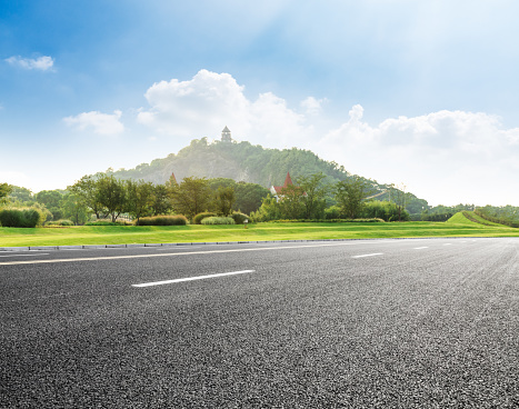 empty asphalt road and mountain nature landscape in city park