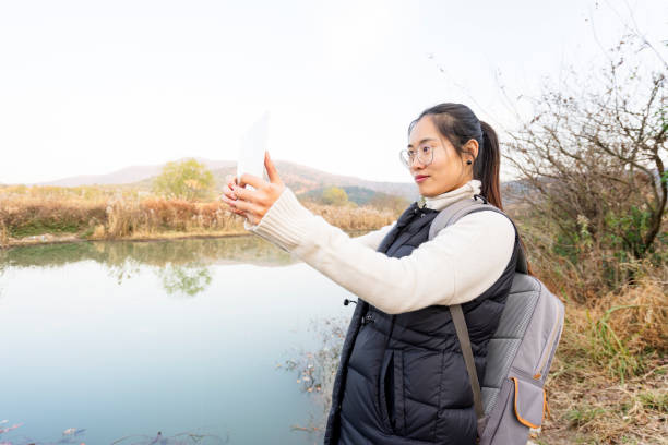 istock young female using digital tablet to take photo of scenery 898458764