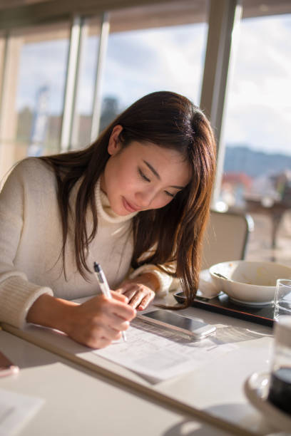 istock Beautiful woman writing document after lunch 898458906