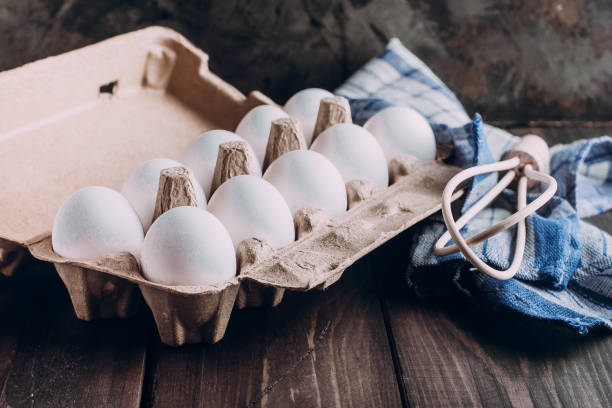 istock Wooden Whisk and Eggs on wooden kitchen table. Bake concept 898470436