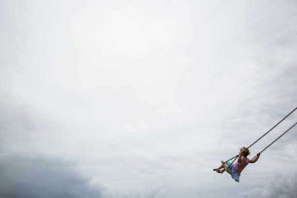 istock Girl swinging happily 898470474