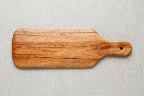 istock Handmade wood cutting board on the linen 898470714