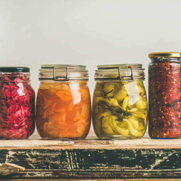 istock Autumn pickled colorful vegetables in jars placed in row 898470728