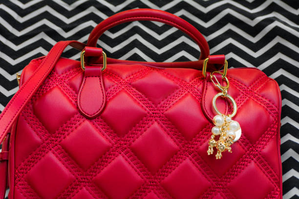 Beautiful red Purse with gold pearl keychain in front of zigzag pattern