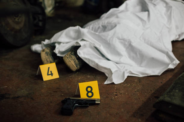 Crime scene investigation - covered human body and evidences A photo showing covered dead body and founded evidence while investigating a crime scene. criminal investigation photos stock pictures, royalty-free photos & images