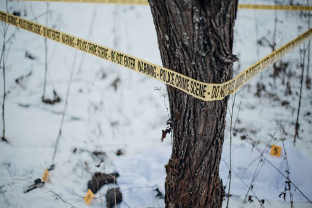 istock Crime scene marked with a tape - dead body and evidence 898475810