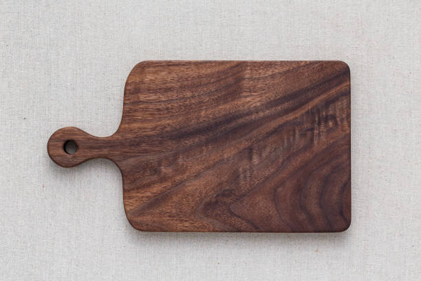 istock Walnut handmade wood cutting board on the linen 898483304
