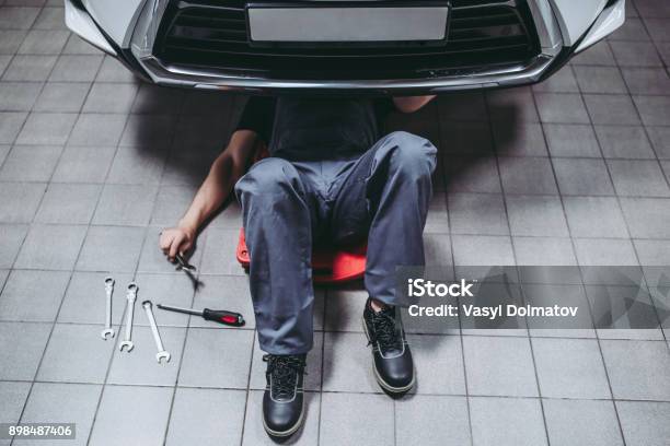 Handsome Auto Service Mechanics Stock Photo - Download Image Now - Car, Below, Mechanic