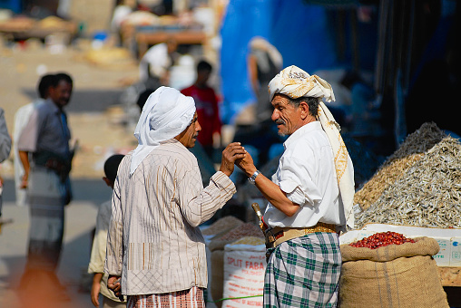 Sanaa, Yemen - September 18, 2006: Two unidentified senior men talk at the street market in Sanaa, Yemen.