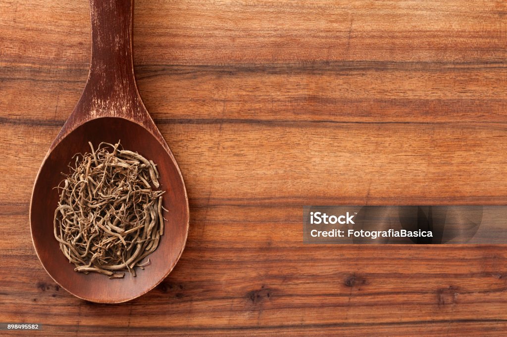 Valerian root Top view of wooden spoon over table with valerian root on it Valerian - Herb Stock Photo