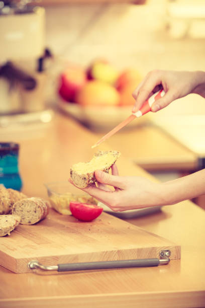 Woman preparing healthy breakfast making sandwich