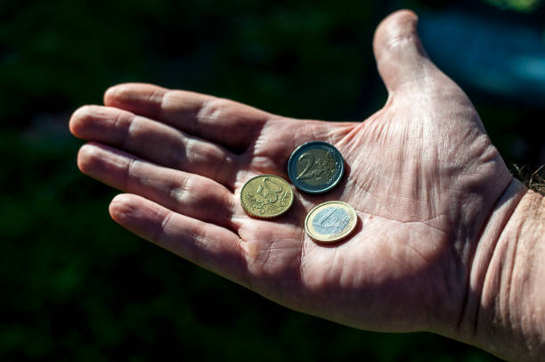 istock Big hand with euro coins 898506184