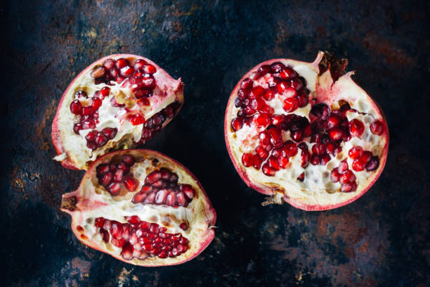 istock Top view of pomegranate fruit quarters and halves. 898513722