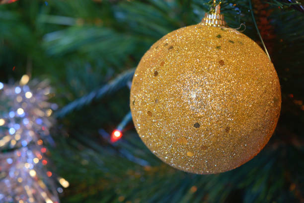 istock christmas balls on tree with lights and stars 898516024