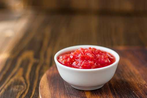 Indian chutney or mexican salsa in white ceramic bowl