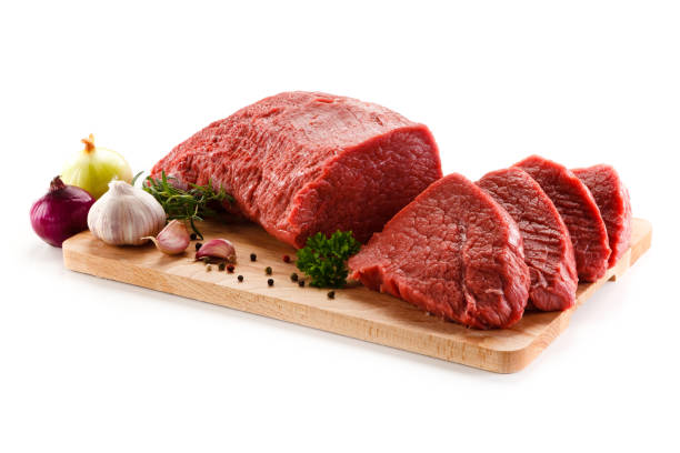 Raw beef on cutting board and vegetables Raw sirloin beef on cutting board and vegetables on white background garlic bulb photos stock pictures, royalty-free photos & images