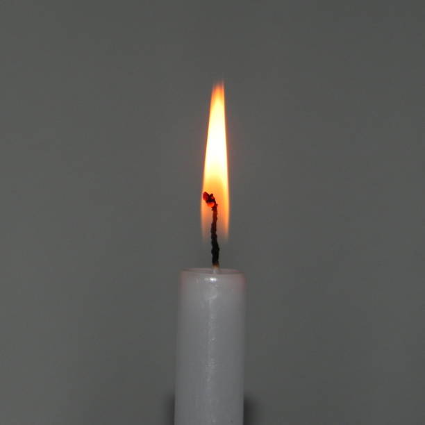 istock lit candle, christmas lights 898533856