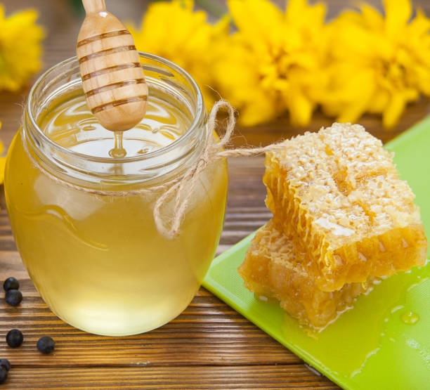 istock Delicious delicious honey in  jar on table 898535058
