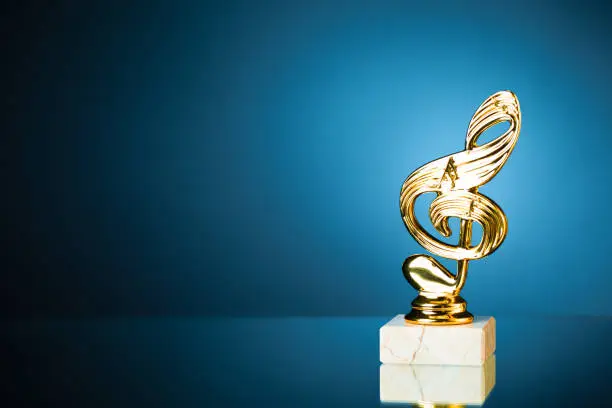 treble clef symbol trophy on blue background with copy-space