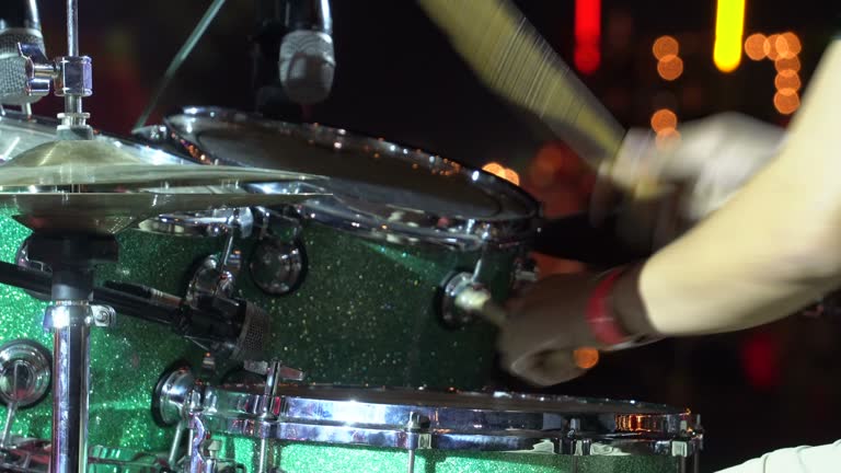 Drummer playing on drum set. close up. Drummer on stage