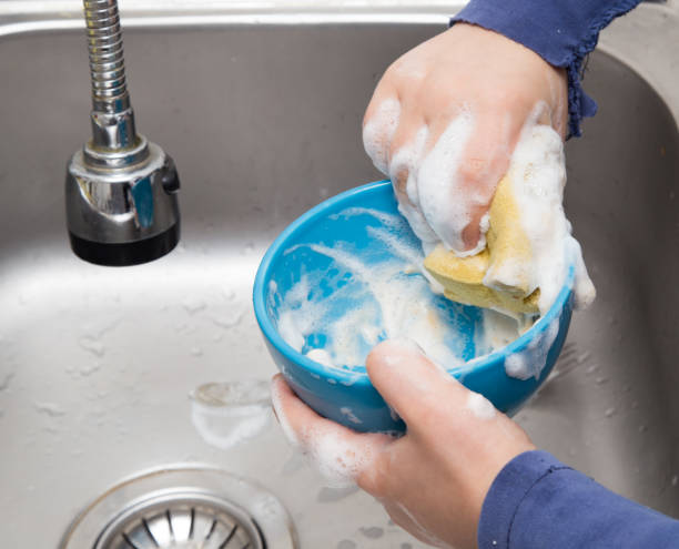 istock boy washing dishes in the kitchen 898548630