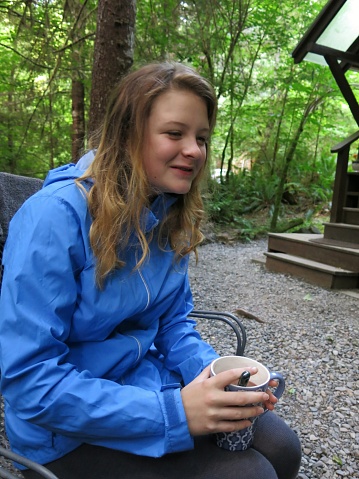 Camping Teenager Stirring Hot Chocoate Coffee in Mug