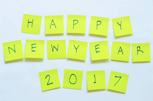 istock paper note writing happy new year 2017 stick on white background 898549414