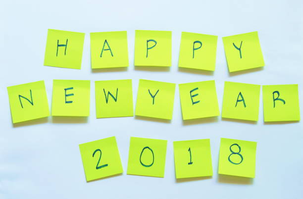 istock paper note writing happy new year 2018 stick on white background 898549468