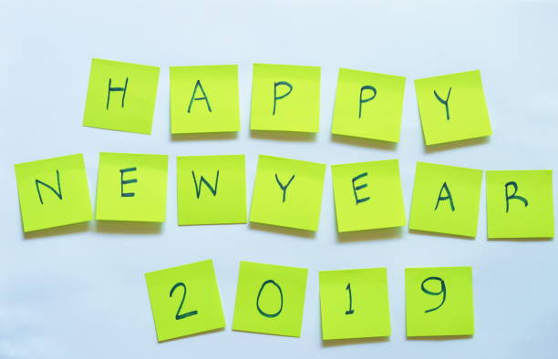 istock yellow paper note writing happy new year 2019 on white background 898549486