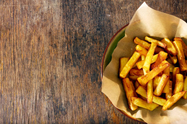istock Fried potatoes in plate pan on wooden background with border, top view 898552120
