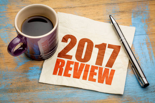 2017 review on napkin 2017 review text on a napkin with a cup of coffee 2017 stock pictures, royalty-free photos & images