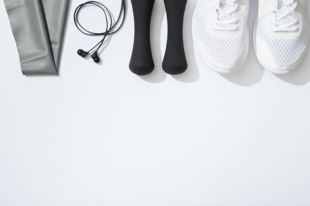 istock Fitness flat lay, dumbbells, notebook, headphones, notebook, towel on white background 898556364