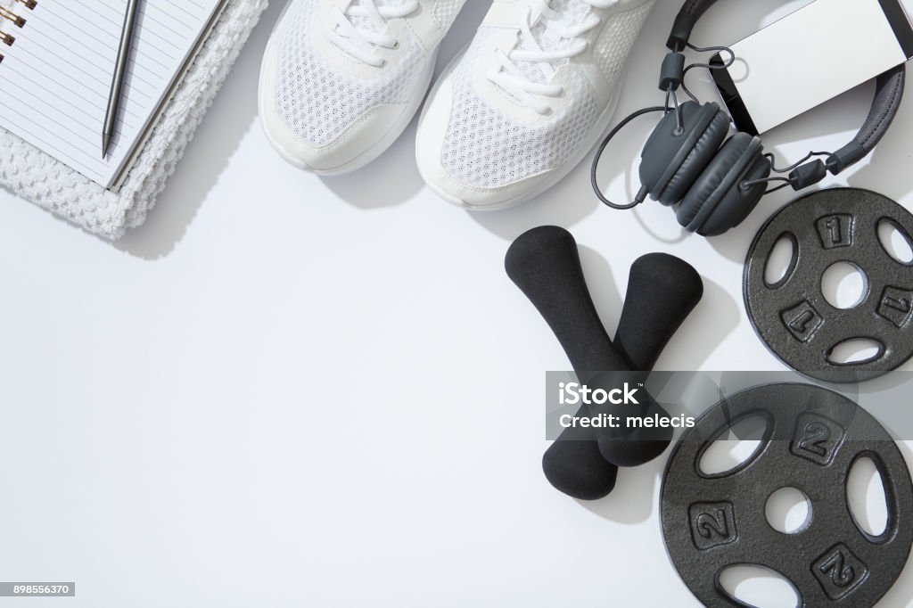 Fitness flat lay, dumbbells, notebook, headphones, notebook, towel on white background Healthy Lifestyle, Exercising, Wellbeing, Sport, Flat Lay, Exercise Equipment, Healthy Lifestyle Stock Photo