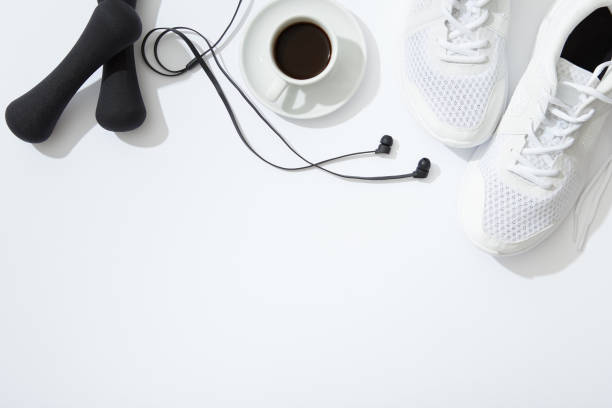 istock Fitness flat lay, dumbbells, notebook, headphones, notebook, towel on white background 898556372