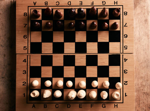 istock Chess pieces and chessboard on a wooden table 898562760