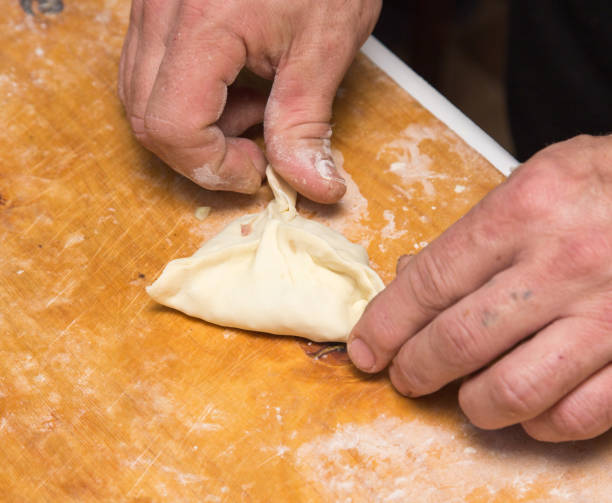 istock man prepares dumplings at home 898562870