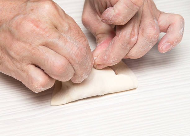 istock man prepares dumplings at home 898563188