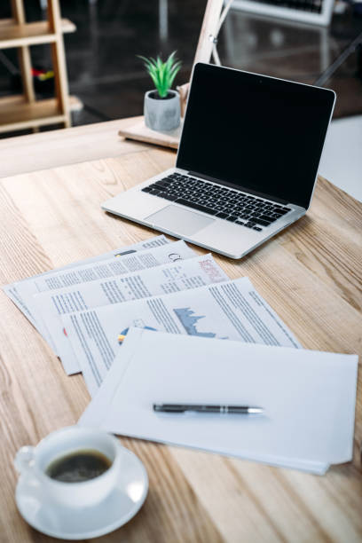 istock cup of coffee and laptop on table 898563512