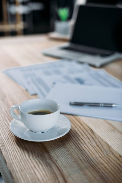 istock cup of coffee and laptop on table 898564034