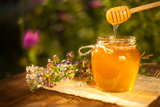istock Delicious delicious honey in  jar on table 898566452