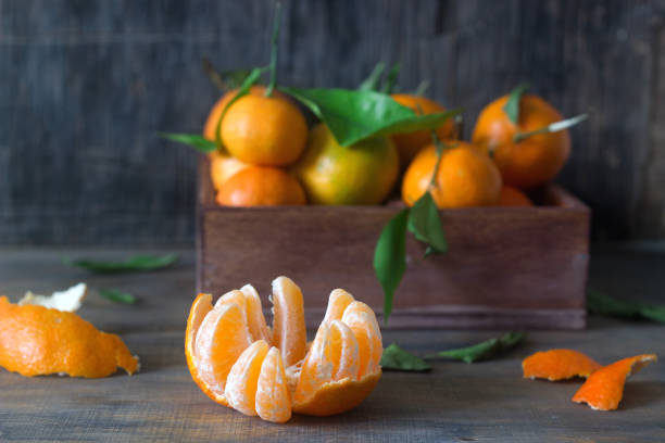 istock Mandarins in a wooden box on a wooden background. Rustic style. 898567308