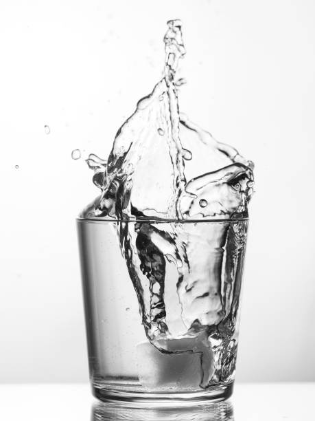 Splash in a glass of water from an ice cube
