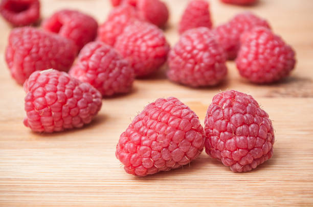 istock raspberries on wooden cutting board in bamboo texture 898578132