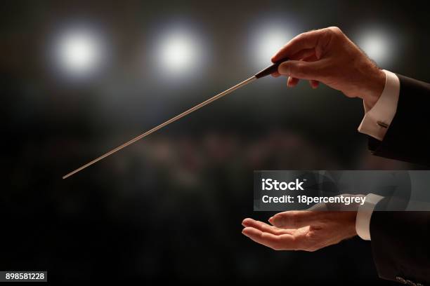 Conductor Conducting An Orchestra Stock Photo - Download Image Now - Musical Conductor, Opera, Classical Music