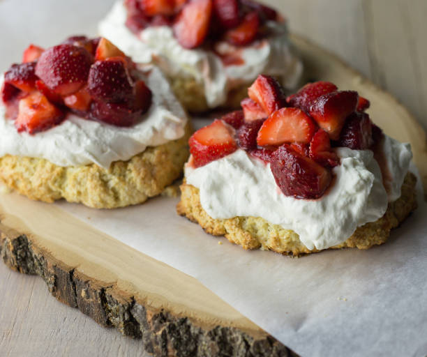 istock Three strawberry shortcake treats on a wooden serving platter. 898581682