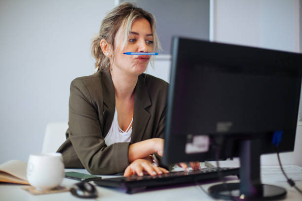 Bored or incompetent businesswoman at work Bored or incompetent businesswoman at work wasting time photos stock pictures, royalty-free photos & images
