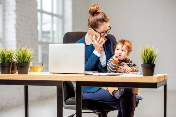istock Multitasking businesswoman with her son working at the office 898585496