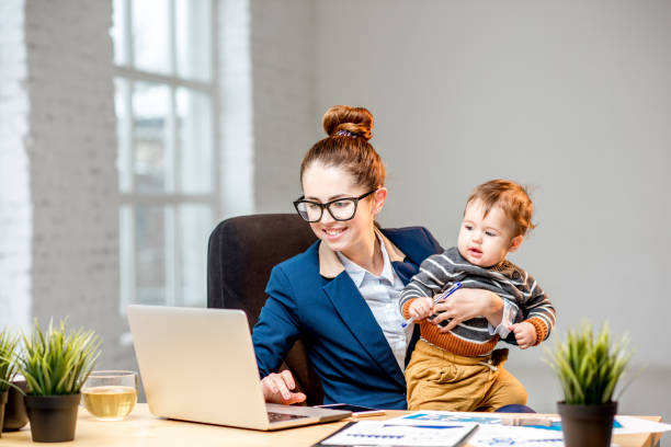 istock Multitasking businesswoman with her son working at the office 898585794