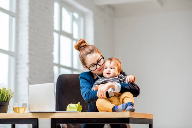 istock Multitasking businesswoman with her son working at the office 898585978